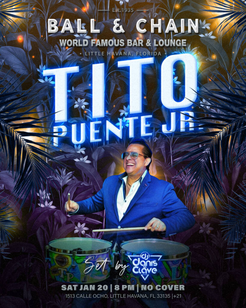 Tito Puente Jr playing the timbales on stage in a tuxedo