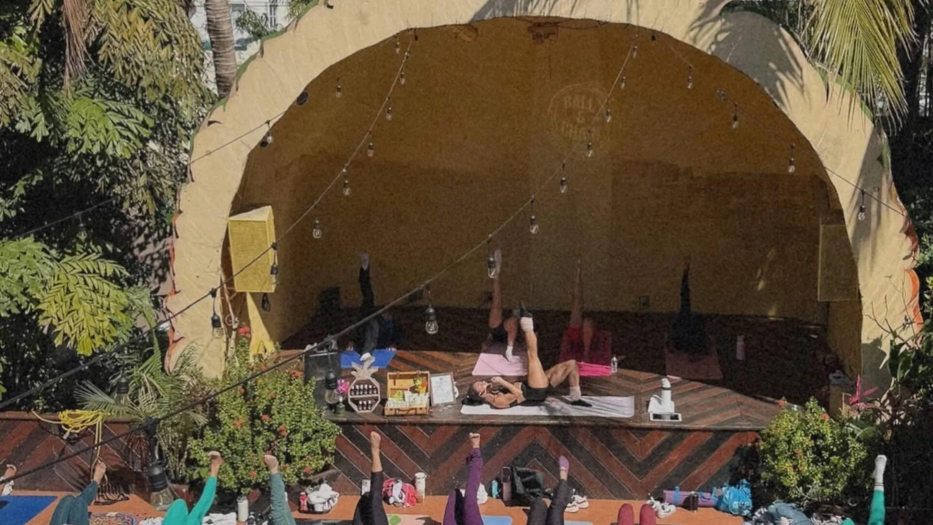 People doing pilates on the pineapple stage at ball & chain