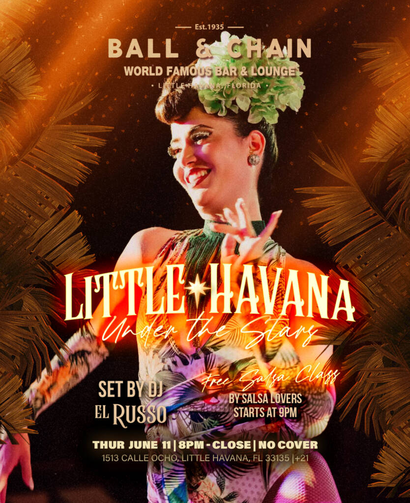 a showgirl with a feathered headdress on stage at Ball & Chain Miami